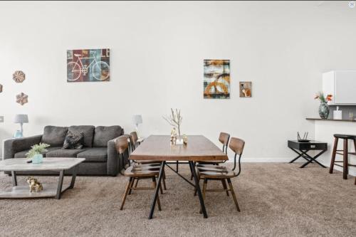 a living room with a table and a couch at CozySuites - 2BR with Direct Skybridge Access #6 in Indianapolis