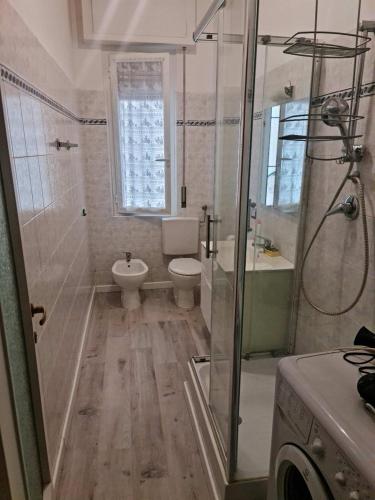 a bathroom with a shower and a toilet and a sink at Partenope in Levanto