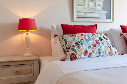 a bed with a pillow and a lamp on a night stand at HarTeluk Joure in Joure