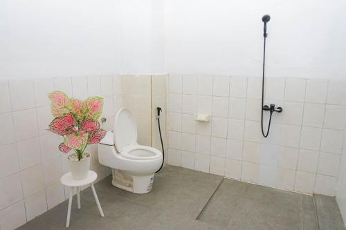 a bathroom with a toilet and a plant in it at Panorama cottages 1 #31 in Legian