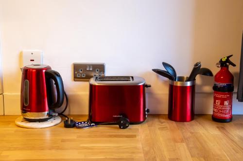 a kitchen counter with two coffee makers and aperature at 5 wheelhouse apartments in Lochinver