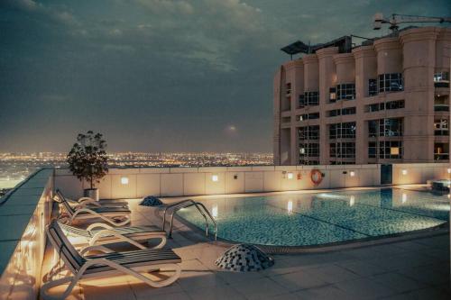 a swimming pool on the roof of a building at Luxury 3 Bedroom Sub Penthouse With Rooftop Pool in Dubai