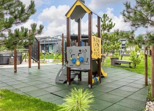 a playground with a slide in a park at Gold holiday Apartments - "Fairy Tale Forest" Mano jūra 2 in Palanga