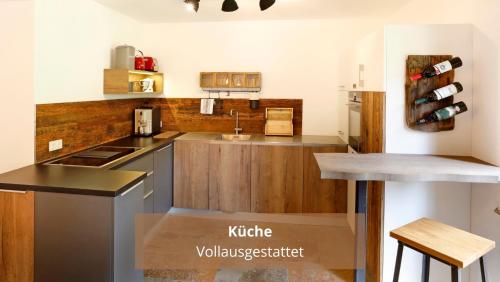 a kitchen with a sink and a counter top at Chalet WaldHäusl luxuriöse Ferienwohnungen mit Sauna & Whirlpool, Kamin, Balkon oder Terrasse mit Bergblick in Heiligenblut
