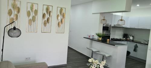 a kitchen with white cabinets and a counter top at Cazino Apartamento III in Praia