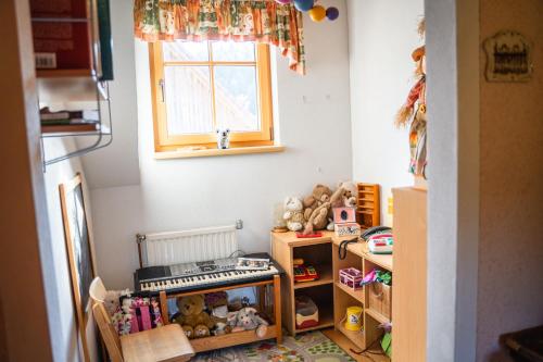 a childs play room with toys and a window at Singerskogel - Ferienhof und Jausnstub`n in Spital am Pyhrn