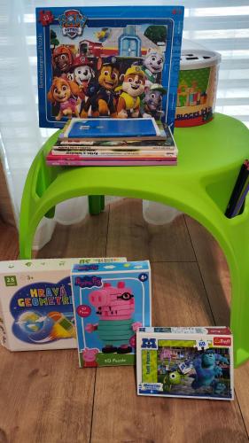 a green table with childrens toys on top of it at Nový Exkluzívny 2 izbový apartmán Rajpark Residence Rajecké Teplice in Rajecké Teplice