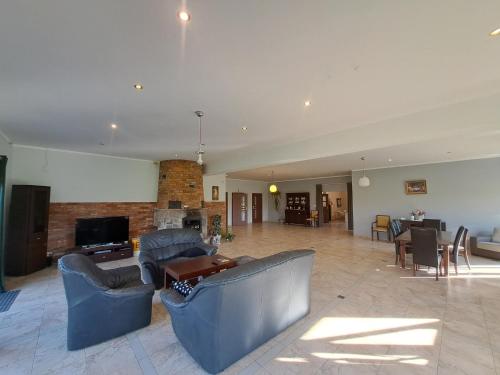 a large living room with two couches and a fireplace at Pokoje u pawla in Miechucino