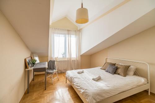 a bedroom with a bed and a desk in it at Kraków Charm in Krakow