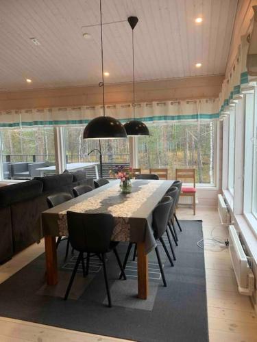 a dining room with a table and some chairs at Villa Hellitä - big, private and great location in Ylläsjärvi