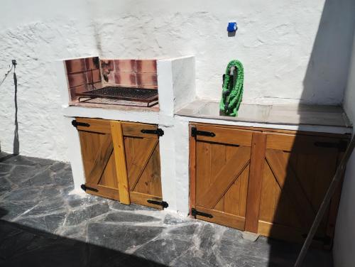 a kitchen with wooden cabinets and a counter top at Casa San Clemente del Tuyú in San Clemente del Tuyú