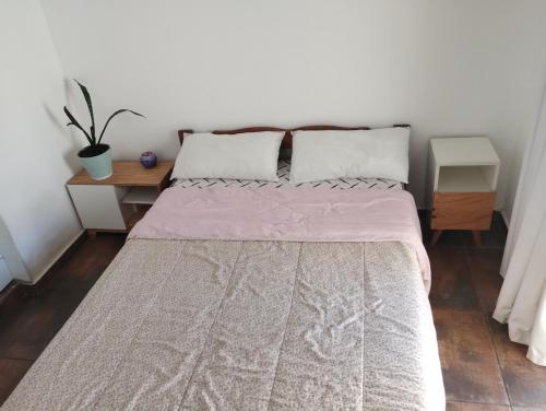 a bedroom with a large bed with two pillows at Casa San Clemente del Tuyú in San Clemente del Tuyú