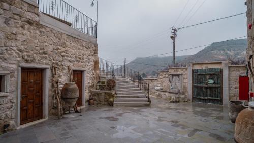 a stone building with a staircase and a stair case at Theodora Village House in Urgup