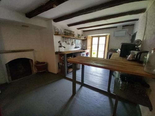 a living room with a table and a fireplace at Room in Apartment - Casa Coerente Cavergno Room no 4 in Cevio