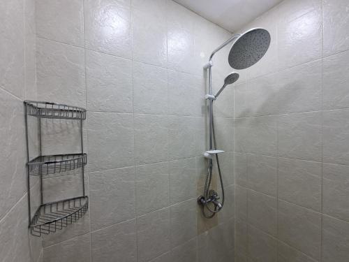 a shower with a shower head in a bathroom at Sahil city view in Baku