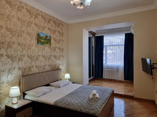 a bedroom with a bed with a stuffed animal on it at Sahil city view in Baku