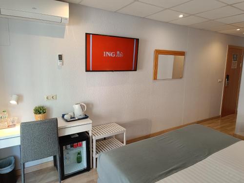 a room with a bed and a desk and a table at Mendez Nuñez Alicante in Alicante