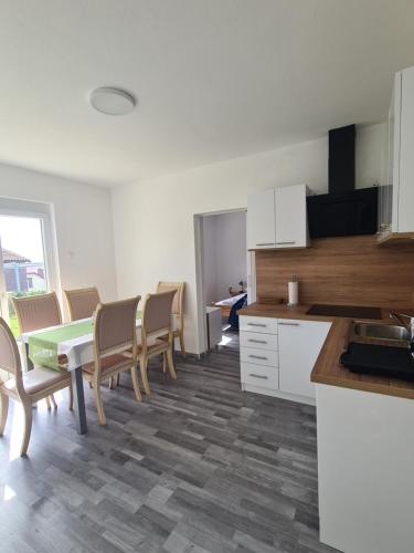 a kitchen and dining room with a table and chairs at Počitniški dom Portorož / Portoroz Holiday Home in Portorož