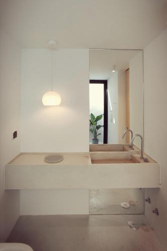 a bathroom with a sink and a mirror at Square House . Comporta, Portugal in Comporta