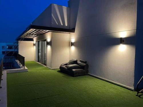 a living room with a couch and green carpet at Marassi blanca in El Alamein