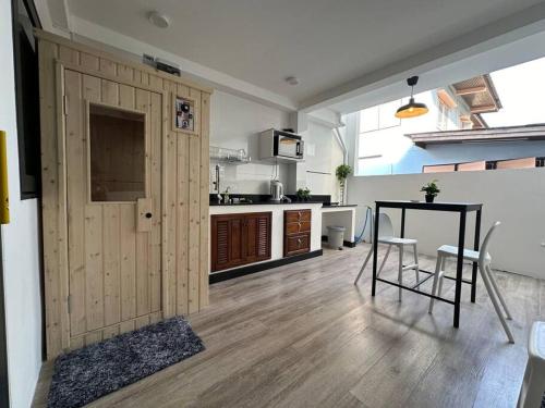 a kitchen and dining room with a table and a table at Private cozy house @Chatcuchak in Bang O