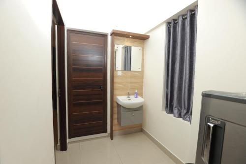 a small bathroom with a sink and a toilet at Vvp Airport Lounge in Nedumbassery