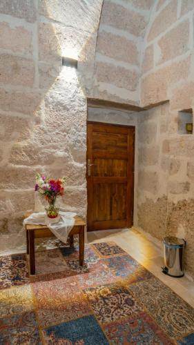 a room with a table and a wooden door at Theodora Village House in Urgup
