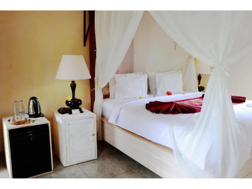 Кровать или кровати в номере Gongwi Cottages Sidemen