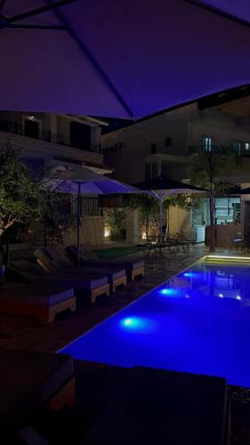 a pool with blue lights in a building at night at Casa Del Mar in Ksamil