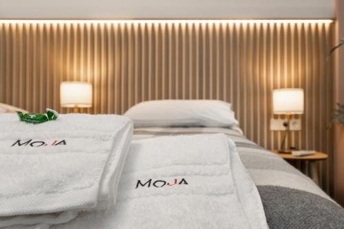 a hotel room with two towels on a bed at Moja Accommodation in Kaunas