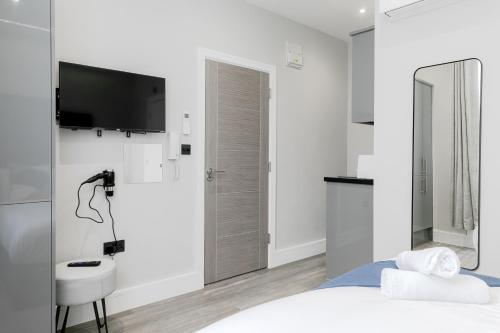 a bedroom with a bed and a sink and a mirror at London Central Studios in London