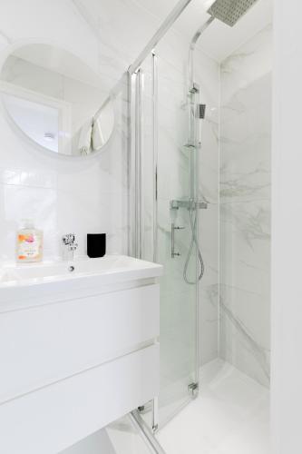a white bathroom with a sink and a shower at London Central Studios in London