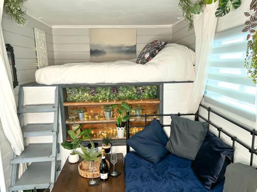 a tiny house with a bed and a table at Quirky Vintage Horsebox Truck in Balcombe