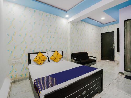 a bedroom with a bed and a chair at OYO Hotel Moon in Rajkot