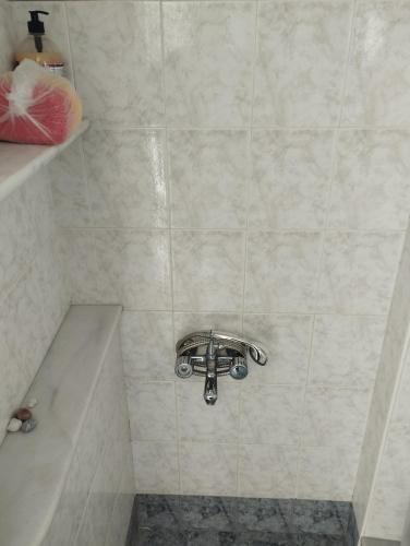 a bathroom with a shower with a faucet at My Sisters House in Agios Nikolaos