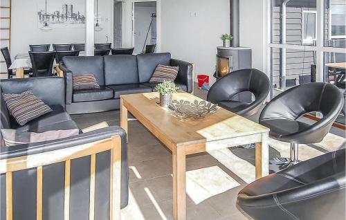 a living room with a couch and a table and chairs at Awesome Home In Haderslev With Wifi in Kelstrup