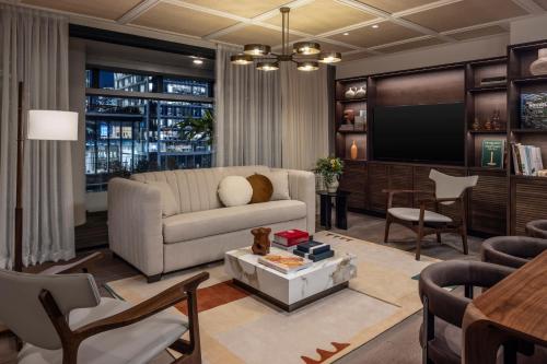 a living room with a couch and a tv at The George Tel Aviv in Tel Aviv