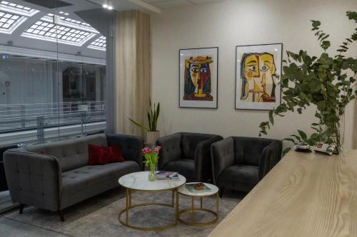 a living room with two couches and a table at Art Hotel William in Bratislava
