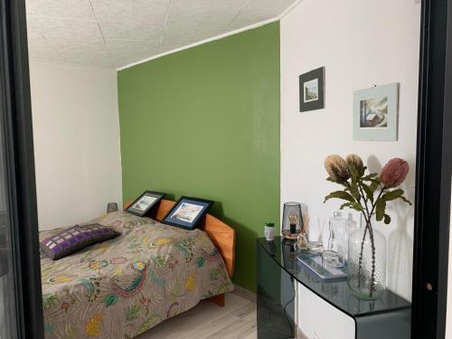 a bedroom with a bed and a table with pictures on it at T2 au calme montagne et lac in La Bâtie-Vieille