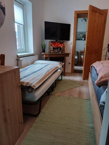 a bedroom with a bed and a flat screen tv at Appartement Franz in Bad Ischl
