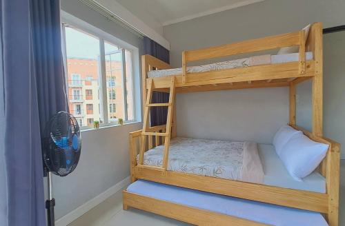 a bunk bed in a room with a window at 88 Gibraltar (Mines View) in Baguio
