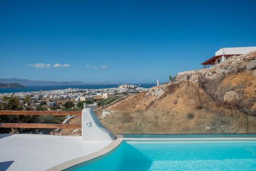 a swimming pool with a view of a hill at Nèsoi Villas Naxos in Naxos Chora