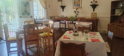 a dining room with two tables and chairs at Heidelberg Central B&B in Heidelberg