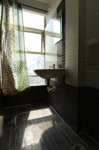 a bathroom with a sink and a window at ON GREEN RESIDENCY in Secunderabad