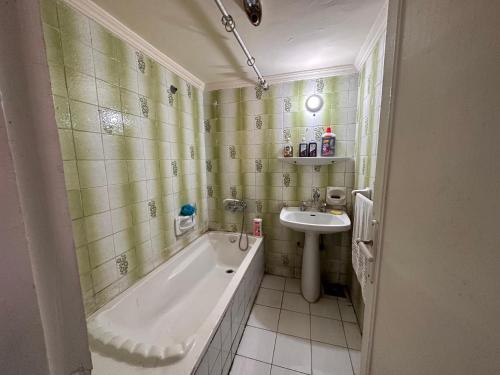 a bathroom with a tub and a sink at Mariamish ‘s place in Alexandria