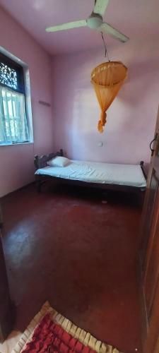 a room with a bed and a ceiling fan at Chandani villa in Galle