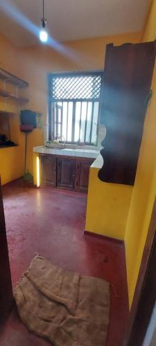 an empty room with a kitchen and a window at Chandani villa in Galle