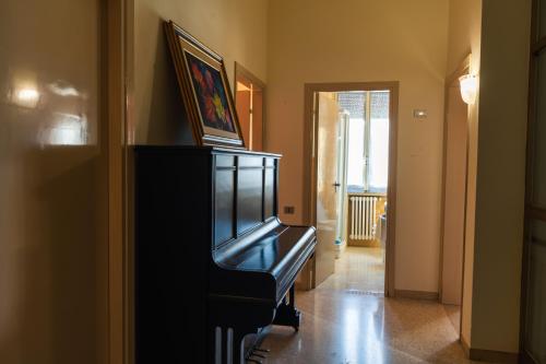 a piano in a hallway with a painting on top of it at Casa di nonna in Bevagna