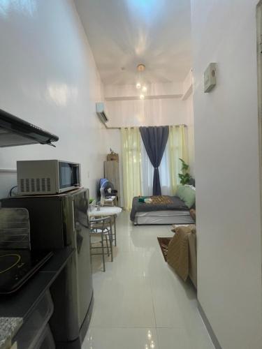 a room with a kitchen and a living room at South Residences in Manila