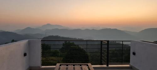 a balcony with a bench and a view of mountains at Mount View Cottage in Gampola